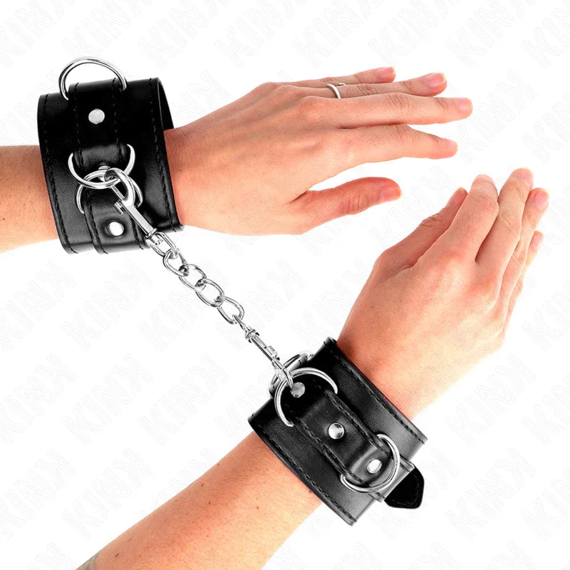 KINK - MUÑEQUERAS CON 3 ANILLAS EN D AJUSTABLE NEGRO 17.5-25 CM X 6 CM - Nuvica