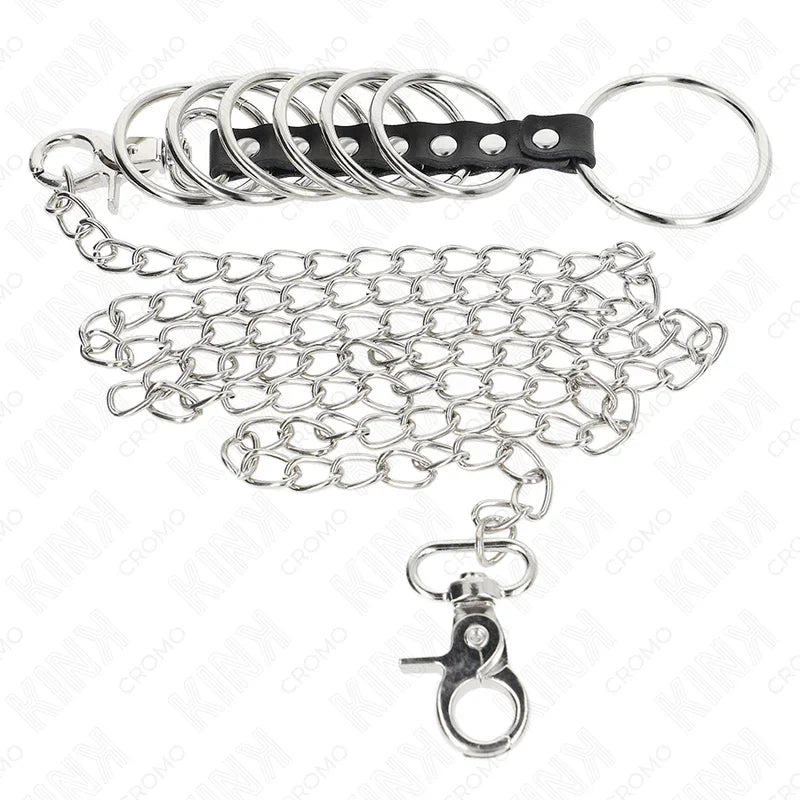 KINK - 7 ANILLOS PENE METAL 3.8 CM A 5 CM CONECTADOS CON POLIPIEL Y CADENA METAL 100 CM - Nuvica