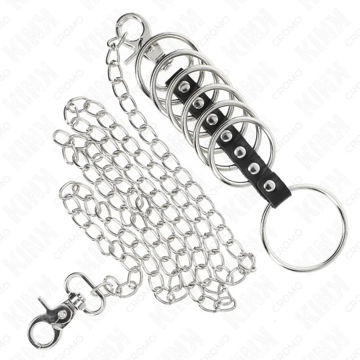 KINK - 7 ANILLOS PENE METAL 3.8 CM A 5 CM CONECTADOS CON POLIPIEL Y CADENA METAL 100 CM - Nuvica